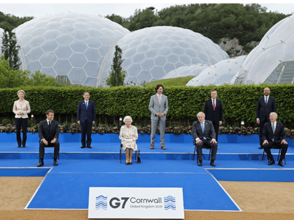 Britain's Queen Elizabeth II (C), poses for a family photograph with, from left, Germany's Chancellor Angela Merkel, President of the European Commission Ursula von der Leyen, France's President Emmanuel Macron, Japan's Prime Minister Yoshihide Suga, Canada's Prime Minister Justin Trudeau, Britain's Prime Minister Boris Johnson , Italy's Prime minister Mario …