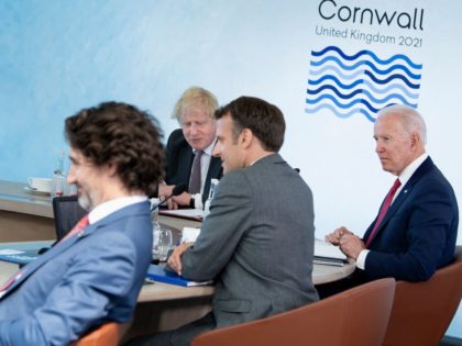 (L-R) Canada's Prime Minister Justin Trudeau, Britain's Prime Minister Boris Johnson, France's President Emmanuel Macron and US President Joe Biden wait for the start of a working session at the G7 summit in Carbis Bay, Cornwall on June 12, 2021. - G7 leaders from Canada, France, Germany, Italy, Japan, the …