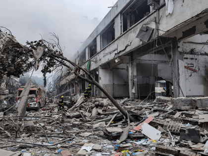 Workers search for victims in a building damaged by a gas line explosion which left at least 12 people dead and nearly 140 others injured in Shiyan, in central China's Hubei province on June 13, 2021. - China OUT (Photo by - / CNS / AFP) / China OUT (Photo …