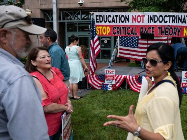 People talk before the start of a rally against "critical race theory" (CRT) being taught in schools at the Loudoun County Government center in Leesburg, Virginia on June 12, 2021. - "Are you ready to take back our schools?" Republican activist Patti Menders shouted at a rally opposing anti-racism teaching …