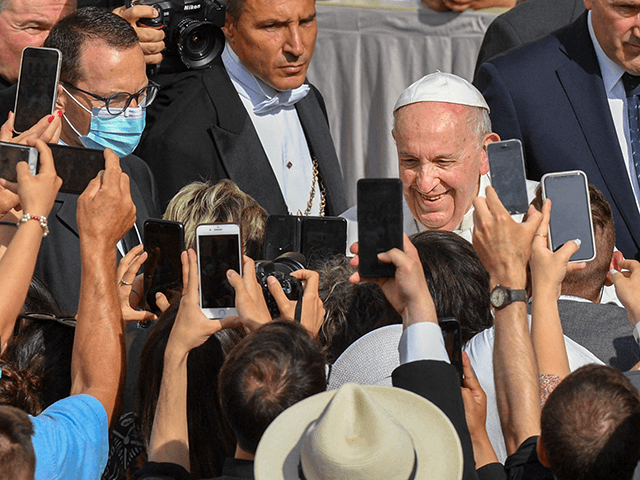 Attendees take photos of Pope Francis as he arrives to hold his weekly general audience at San Damaso courtyard on June 16, 2021 in The Vatican. (Photo by Tiziana FABI / AFP) (Photo by TIZIANA FABI/AFP via Getty Images)