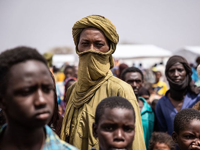 TOPSHOT - Refugees stand in Goudebou, a camp that welcomes more than 11,000 Malian refugee