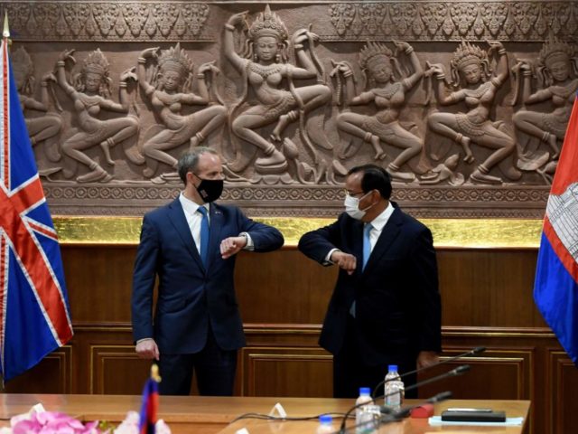 Cambodia's Foreign Minister Prak Sokhonn (L) greets Britain's Foreign Secretary