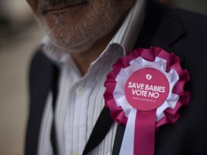 A man wears a rosette against abortion outside a polling station in Gibraltar, on June 24, 2021, during a referendum to ease an abortion law. - Gibraltar began voting on plans to ease its draconian abortion law in a referendum delayed for over a year by the coronavirus pandemic. The …