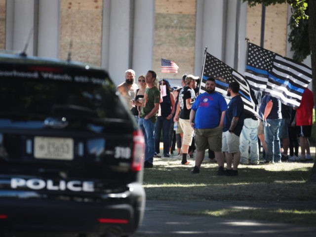 KENOSHA, WISCONSIN - AUGUST 30: Demonstrators hold a Back the Blue Rally in front of the Kenosha County Courthouse on August 30, 2020 in Kenosha, Wisconsin. The city is recovering from several days of unrest and demonstrations after Jacob Blake was shot several times at close range in the back …