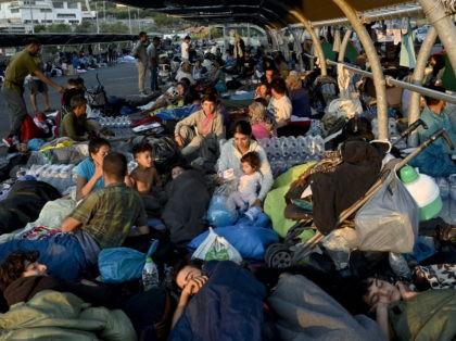 MYTILENE, GREECE - SEPTEMBER 10: Refugees find shelter outside Lidl supermarket next to road close to Mytilene town, after a fire destroyed Moria Refugee Camp on the island of Lesbos, on September 11, 2020 in Mytilene, Greece. A massive fire ravaged the island's main migrant camp on Tuesday night leaving …