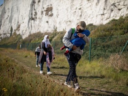 DEAL, ENGLAND - SEPTEMBER 15: A migrant family walks along the coast on September 15, 2020