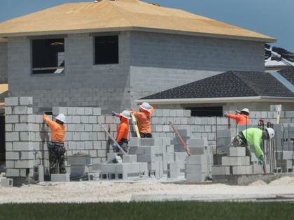 MIAMI, FLORIDA - APRIL 16: Construction workers build a home on April 16, 2021 in Miami, F
