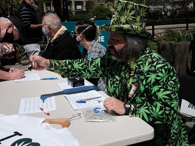 NEW YORK, NEW YORK - APRIL 20: An activist hands out free marijuana cigarettes to people a