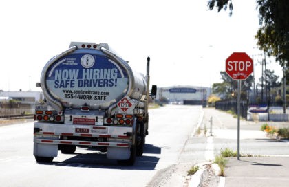 RICHMOND, CALIFORNIA - APRIL 29: A now hiring advertisement appears on the back of a fuel trucks on April 29, 2021 in Richmond, California. A lack of qualified truck drivers could lead to a shortage and gasoline this summer and could cause prices to spike. A gallon of regular unleaded …