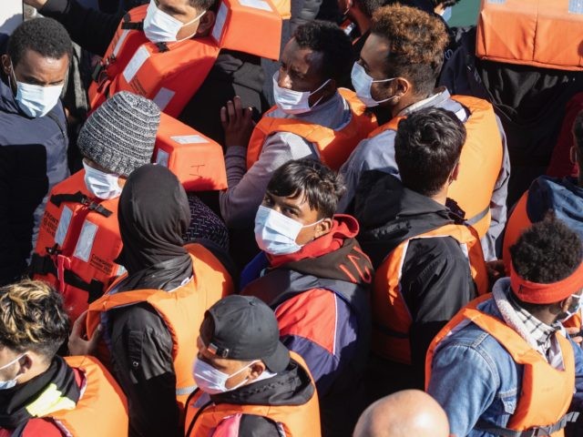 DOVER, ENGLAND - JUNE 09: Newly arrived migrants wait to disembark a Border Force vessel a