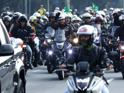 SAO PAULO, BRAZIL - JUNE 12: President of Brazil Jair Bolsonaro (C) rides a motorcycle alo