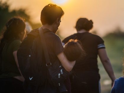 LA JOYA, TEXAS - JUNE 21: A migrant family waits to be accounted for and taken to a border