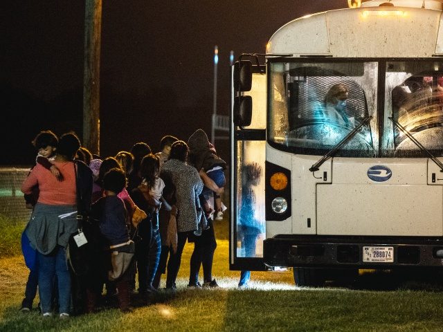 LA JOYA, TEXAS - JUNE 21: Migrants board a bus to be taken to a border patrol processing f