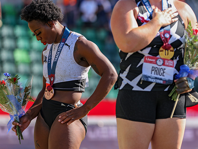 Gwendolyn Berry (L), third place, turns away from U.S. flag during the U.S. National Anthe