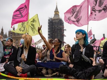 LONDON, ENGLAND - JUNE 27: Extinction Rebellion activists sit down on Westminster Bridge during a protest on June 27, 2021 in London, England. Climate Change action group Extinction Rebellion protest at the perceived control of the UK Media by just four billionaires. (Photo by Rob Pinney/Getty Images)