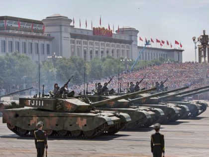 BEIJING, CHINA - SEPTEMBER 03: Chinese soldiers ride in tanks as they pass in front of Tia