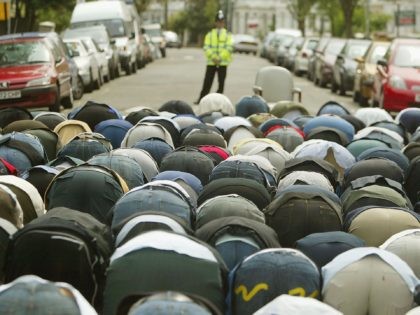 LONDON, ENGLAND - MAY 27: A British police officer watches as followers of radical muslim cleric Abu Hamza al-Masri gather for Friday prayers on May 28, 2004 outside the Finsbury Park mosque in north London, England. Abu Hamza al-Masri was arrested yesterday and remanded in custody pending hearings into his …
