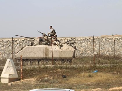 Egyptian army forces drive a tank along the border between the Gaza Strip and Egypt at an area where members of the Palestinian Islamist movement Hamas' security forces are gathering, as Hamas began increasing its forces, in Rafah, in the southern Gaza Strip, on April 21, 2016. (Said Khatib/AFP via …