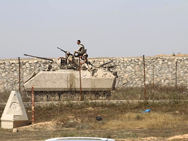 Egyptian army forces drive a tank along the border between the Gaza Strip and Egypt at an area where members of the Palestinian Islamist movement Hamas' security forces are gathering, as Hamas began increasing its forces, in Rafah, in the southern Gaza Strip, on April 21, 2016. Hamas began deploying …