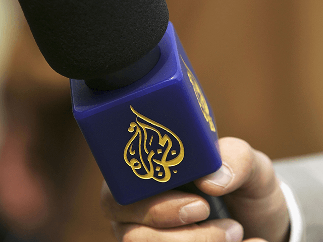 A reporter from the Arabic television channel Al-Jazeera holds a microphone during an interview after a friendly soccer match between Muslim and Christian clerics May 6, 2006 in Berlin, Germany. The game was an event organized under the conference "Football for All: Sport Against Racism" and initiated by Germany's Ecumenical …
