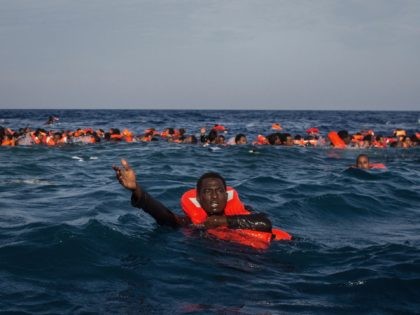 LAMPEDUSA, ITALY - MAY 24: Refugees and migrants are seen swimming and yelling for assistance from crew members from the Migrant Offshore Aid Station (MOAS) 'Phoenix' vessel after a wooden boat bound for Italy carrying more than 500 people capsized on May 24, 2017 off Lampedusa, Italy. Numbers of refugees …