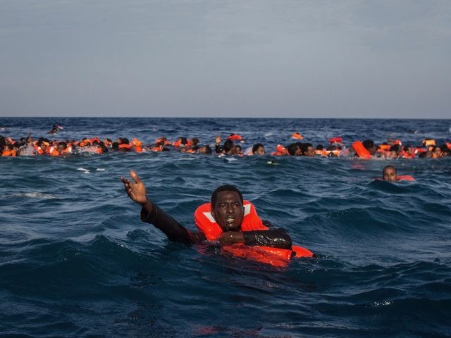 LAMPEDUSA, ITALY - MAY 24: Refugees and migrants are seen swimming and yelling for assista