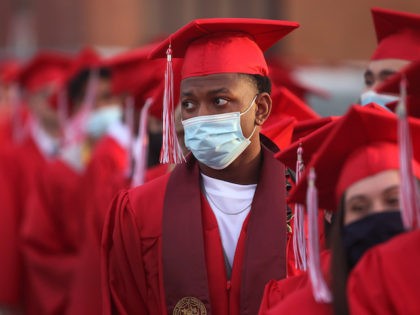 Students prepare to walk out on the football field for their graduation ceremony at Bradley-Bourbonnais Community High School on May 21, 2021 in Bradley, Illinois. Because of social distancing mandates instituted by the state to curtail the spread of COVID-19, last year's graduates were presented with their diplomas in an …