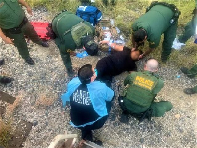 Border Patrol agents rescue a migrant woman who fell under a train while attempting to sneak into the U.S. interior (Photo: U.S. Border Patrol/Laredo Sector)
