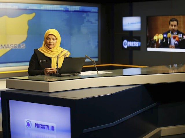 This undated photo provided by Iranian state television's English-language service, Press TV, shows American-born news anchor Marzieh Hashemi at studio in Tehran, Iran. The elder son of Hashemi says his mother is being held in the United States, but has not been charged with anything. Hussein Hashemi says she was …
