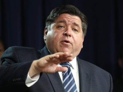 Illinois Gov. J.B. Pritzker responds to a question after announcing that three more people