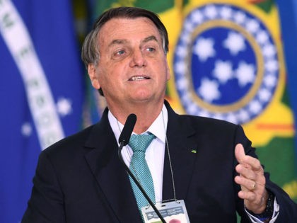 Brazilian President Jair Bolsonaro delivers a speech during the announcement of sponsorship of olympic sports team by the state bank Caixa Economica Federal at Planalto Palace on June 1, 2021. - Brazil's President Jair Bolsonaro said on Tuesday that, if it depends on his government, his country will host the …