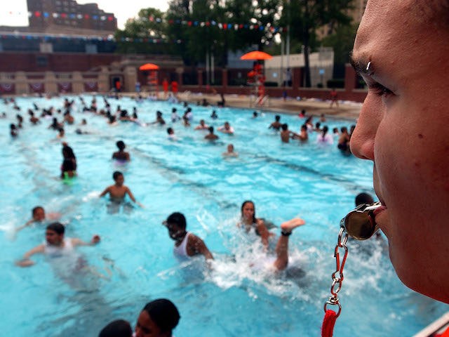 NEW YORK - JUNE 28: Lifeguard Dennis Rodriguez, 17, keeps on eye on swimmers June 28, 2002 on the opening day of New York City's public pools. With a week of temperatures in the 90s, a large turnout arrived for the first swim of the summer. (Photo by Spencer Platt/Getty …