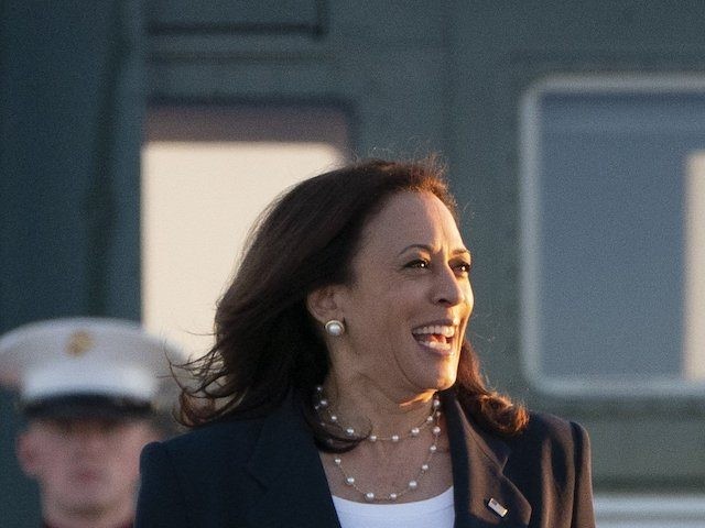 Vice President Kamala Harris, left, walks to board Air Force Two, Friday, June 25, 2021, a