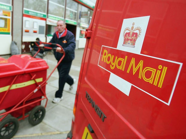 LONDON - NOVEMBER 1: A Royal Mail worker delivers mail ouside of a high street Post Office on November 1, 2004 in London, England. The Royal Mail has dampened down reports that it is too close or sell between 240 and 270 of its larger high street branches which are …