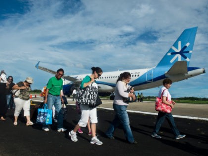 ourists waiting their flight to Mexico City, walk at the airport of Acapulco, Guerrero sta