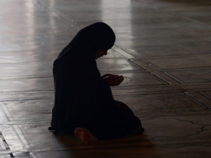An Indian Muslim woman prays at Jama Masjid on the eve of Ramadan in New Delhi on July 10,