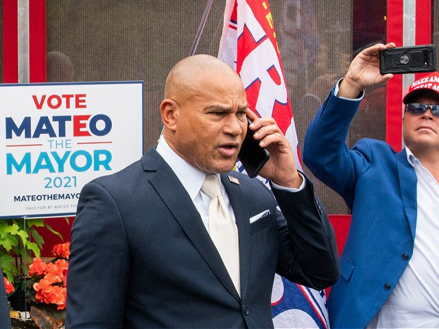 New York City mayoral candidate Fernando Mateo speaks on his mobile as he departs a campai