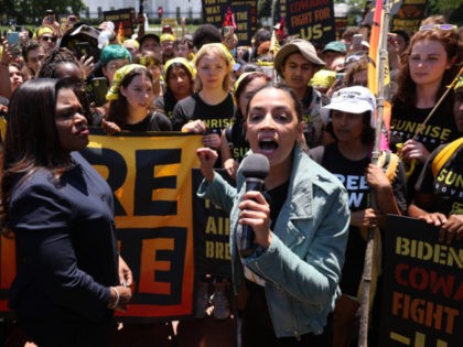 WASHINGTON, DC - JUNE 28: Rep. Cori Bush (D-MO) (L) and Rep. Alexandria Ocasio-Cortez (D-NY) rallying hundreds of young climate activists in Lafayette Square on the north side of the White House to demand that U.S. President Joe Biden work to make the Green New Deal into law on June …