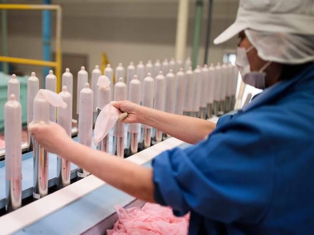 In this picture taken on January 25, 2018, employees of Japanese condom maker Sagami Rubber Industries perform quality tests for randomly picked condoms at the company's testing facility in Atsugi, Kanagawa prefecture. With a little over two years until Tokyo hosts the 2020 Olympic Games, organisers are ramping up preparations, …