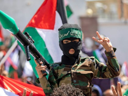 A Yemeni boy holds a mockup rocket during a demonstration in Yemen's third city Taez on May 22, 2021 celebrating "the victory of the Palestinian resistance" against Israel following a ceasefire. - A ceasefire was announced on May 20 between Israel and Palestinian armed groups, including the Islamist movement Hamas, …