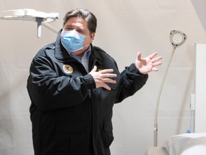 CHICAGO, ILLINOIS - APRIL 17: Illinois Gov. J.B. Pritzker (R) tours one of the patient rooms at the COVID-19 alternate care facility constructed at the McCormick Place convention center in Chicago, Illinois on April 17, 2020 in Chicago, Illinois. The facility, which began seeing patients Thursday, will serve as a …