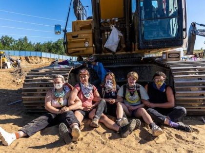 Environmental activists chain themselves to construction equipment at the Line 3 pipeline pumping station near the Itasca State Park, Minnesota on June 7, 2021. - Line 3 is an oil sands pipeline which runs from Hardisty, Alberta, Canada to Superior, Wisconsin in the United States. In 2014, a new route …