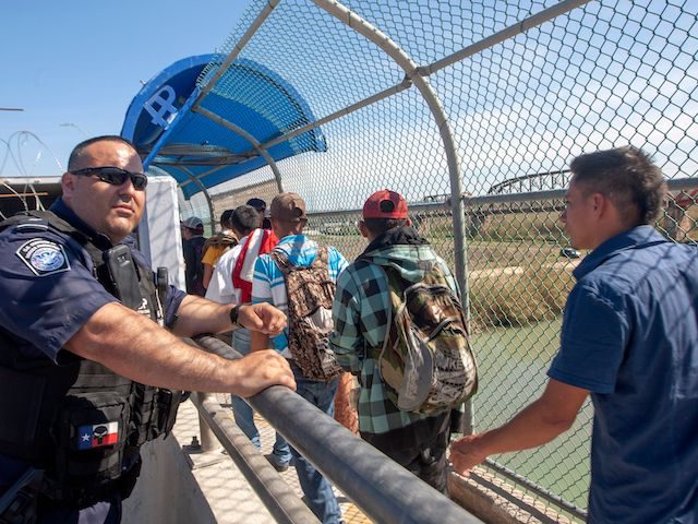 16 Central American migrants cross the International Bridge II to be interviewed by U.S. i