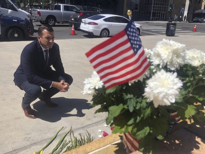 San Jose Mayor Sam Liccardo stops to view a makeshift memorial for the railyard shooting victims in front of City Hall in San Jose, Calif., on Thursday, May 27, 2021. An employee opened fire Wednesday at a California rail yard, killing eight people before taking his own life as law …