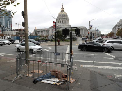 SAN FRANCISCO, CALIFORNIA - DECEMBER 05: A homeless man sleeps on the sidewalk near San Francisco City Hall on December 05, 2019 in San Francisco, California. California Gov. Gavin Newsom announced plans to release $650 million in emergency aid that will allocated to California cities and counties in an effort …