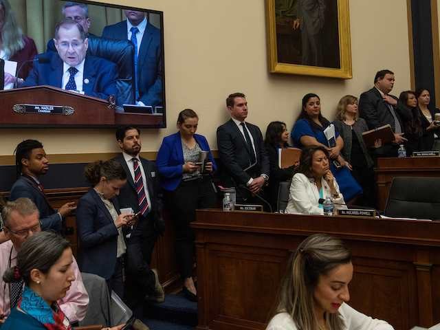 Journalists and staffers listen to Chairman of the House Judiciary Committee, Jerry Nadler (on screen), speak during a markup of a resolution supporting the committee report on Attorney General William Barr's failure to produce the unredacted Mueller report and underlying materials on Capitol Hill in Washington, DC, on May 8, …