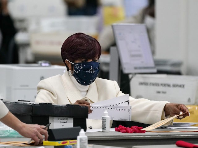 Absentee ballots are processed at the central counting board, Wednesday, Nov. 4, 2020, in Detroit. (AP Photo/Carlos Osorio)