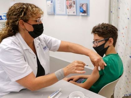 Israeli teen Michael, 12, receives a dose of the Pfizer/BioNTech Covid-19 vaccine at the Maccabi Healthcare Services in the coastal city of Tel Aviv on June 6, 2021, as Israel begins coronavirus vaccination campaign for 12 to 15-year-olds. (Photo by JACK GUEZ / AFP) (Photo by JACK GUEZ/AFP via Getty …