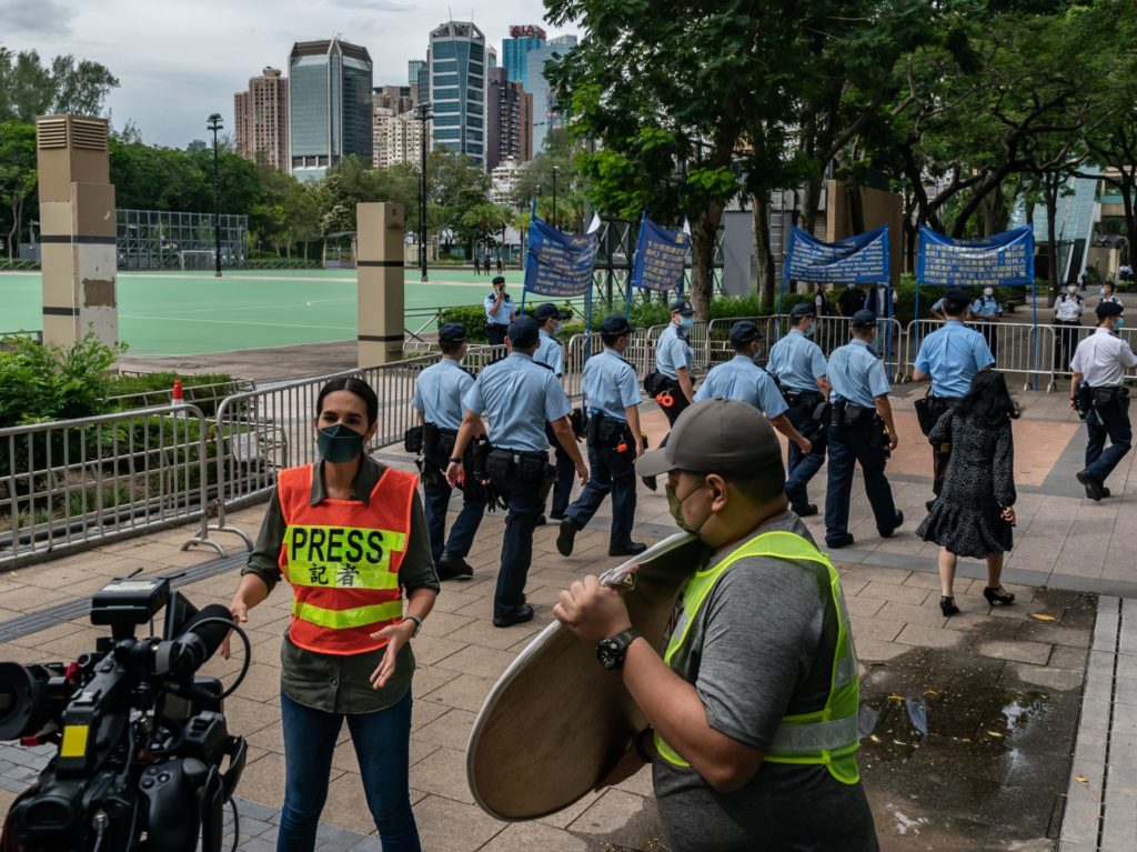 HONG KONG, CHINA - JUNE 04: Police patrol as members of the press film at Victoria Park, after closing a venue where Hong Kong people traditionally gather annually to mourn the victims of the Tiananmen Square crackdown, in the Causeway Bay district on June 4, 2021 in Hong Kong, China. Authorities have banned the gathering, citing the coronavirus pandemic and vowing to stamp out any protests on the anniversary of China's deadly Tiananmen Square crackdown in 1989. (Photo by Anthony Kwan/Getty Images)